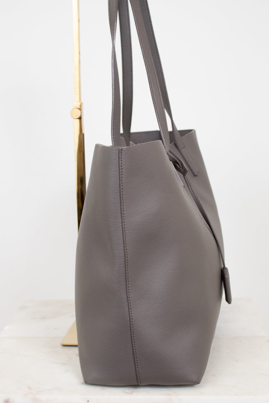Gray leather tote bag on a white background