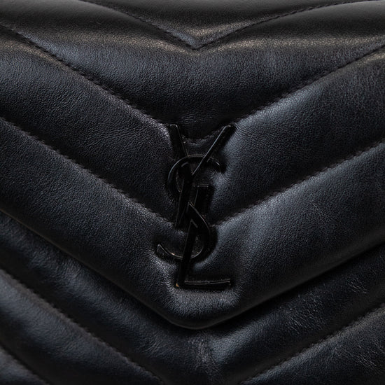 Black quilted handbag with a brand logo on a light background