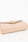 Beige handbag with gold clasp on a white background