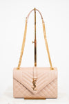 Beige quilted handbag with gold chain strap and logo on a white background