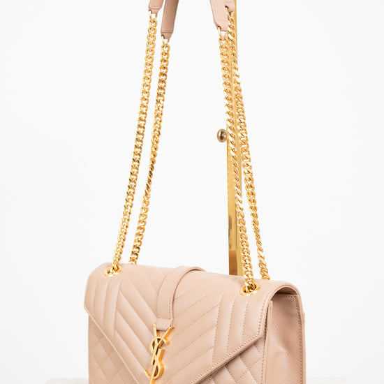 Beige handbag with gold chain strap on a white background