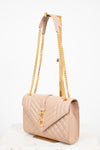 Beige handbag with gold chain strap on a white background
