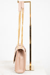Beige handbag with gold chain and handle on a white background