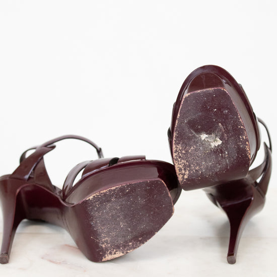 Pair of heels with scuffed soles on a white background