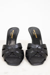 Pair of black sandals with 'Saint Laurent' branding on a white background