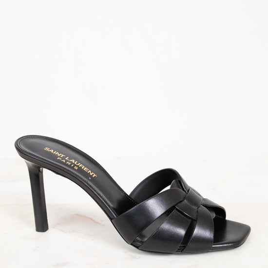 Black sandal with criss-cross design on a white background