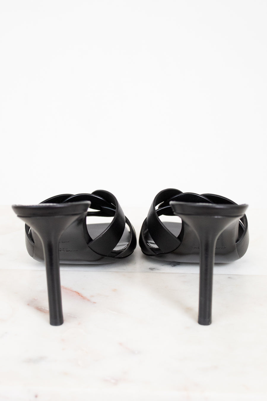 Black high-heeled shoes on a white background