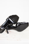 Black high-heeled shoes on a white background