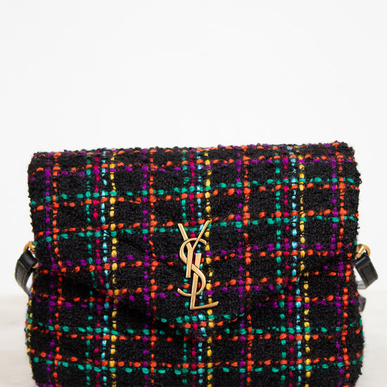 Multicolored tweed handbag with a brand logo on a white background