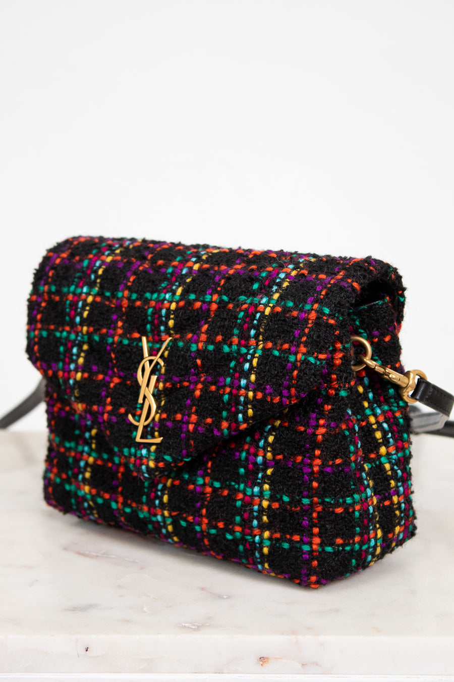 Multicolored tweed handbag with gold hardware on a white background