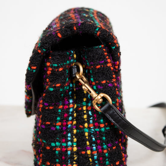 Multicolored textured bag with a gold clasp on a white background