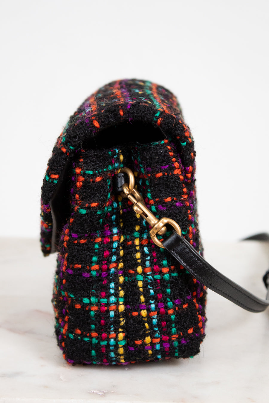 Multicolored textured bag with a gold clasp on a white background