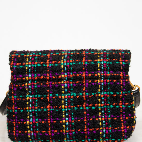 Multicolored plaid handbag on a white background
