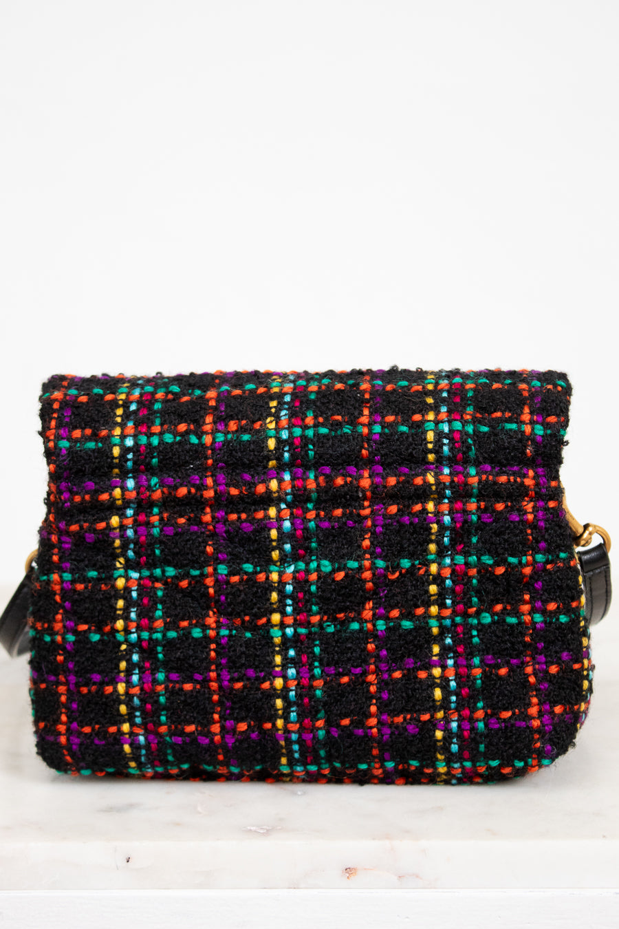 Multicolored plaid handbag on a white background