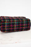 Multicolored checkered fabric purse on a white background