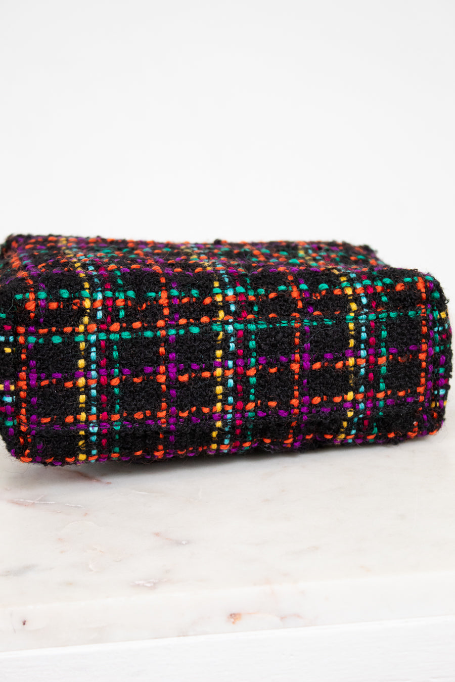 Multicolored checkered fabric purse on a white background