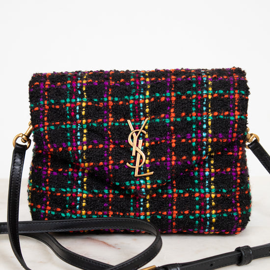 Multicolored textured handbag with a brand logo on a white background