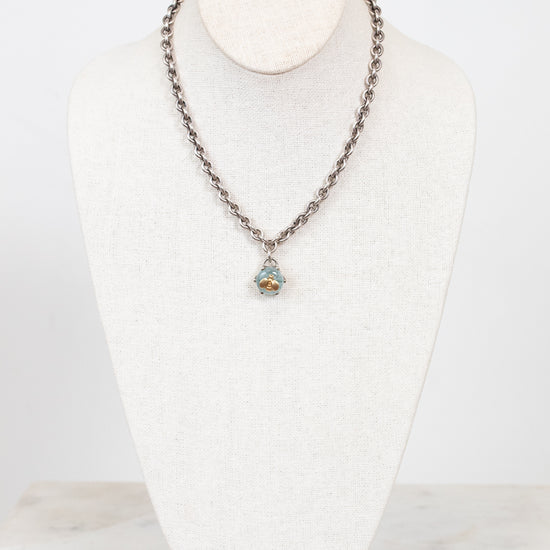 Necklace with a pendant on a white mannequin bust against a white background