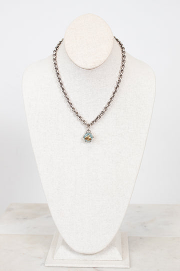 Necklace with a pendant on a white mannequin bust against a white background