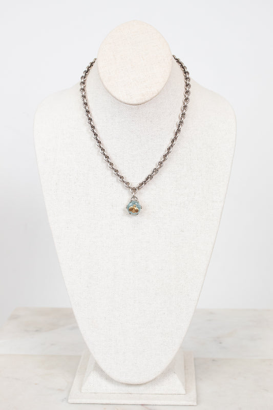 Necklace with a pendant on a white mannequin bust against a white background