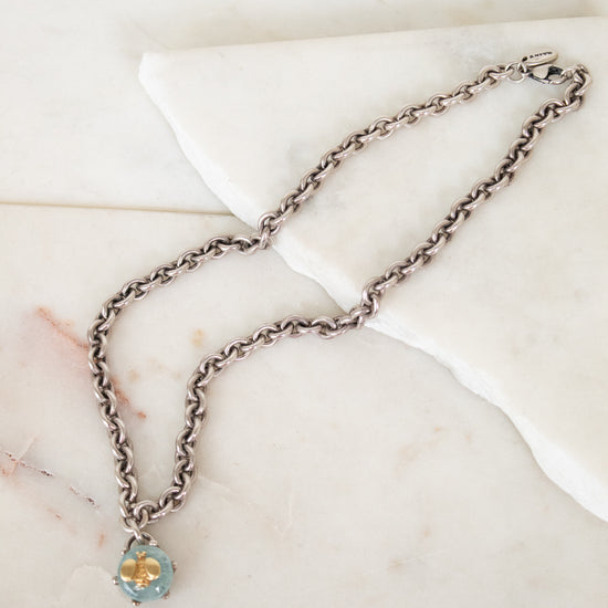 Necklace with a pendant on a marble surface