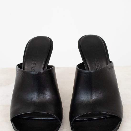 Pair of black open-toe shoes on a light gray background