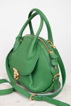 Green handbag with gold accents on a white background