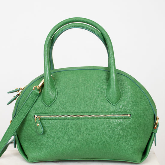 Green handbag with gold accents on a white background