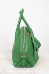 Green handbag with gold zipper and hardware on a white background