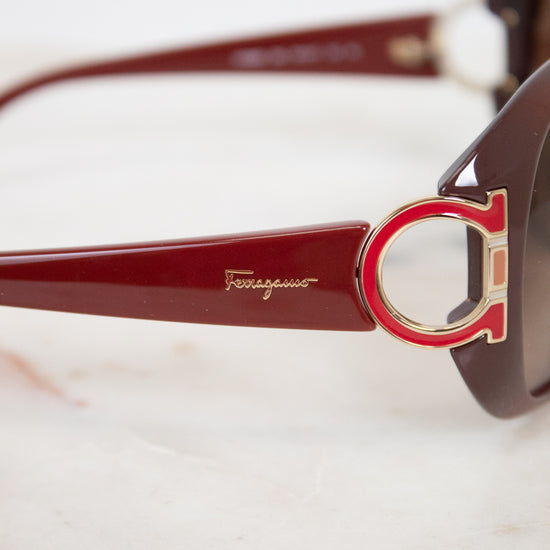 Sunglasses with a prominent brand logo on a light background