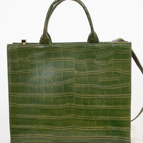 An olive green crocodile-embossed leather handbag with double top handles, displayed on a white marble surface against a white background.