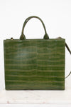 An olive green crocodile-embossed leather handbag with double top handles, displayed on a white marble surface against a white background.
