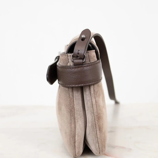Small pouch with a leather strap on a white background