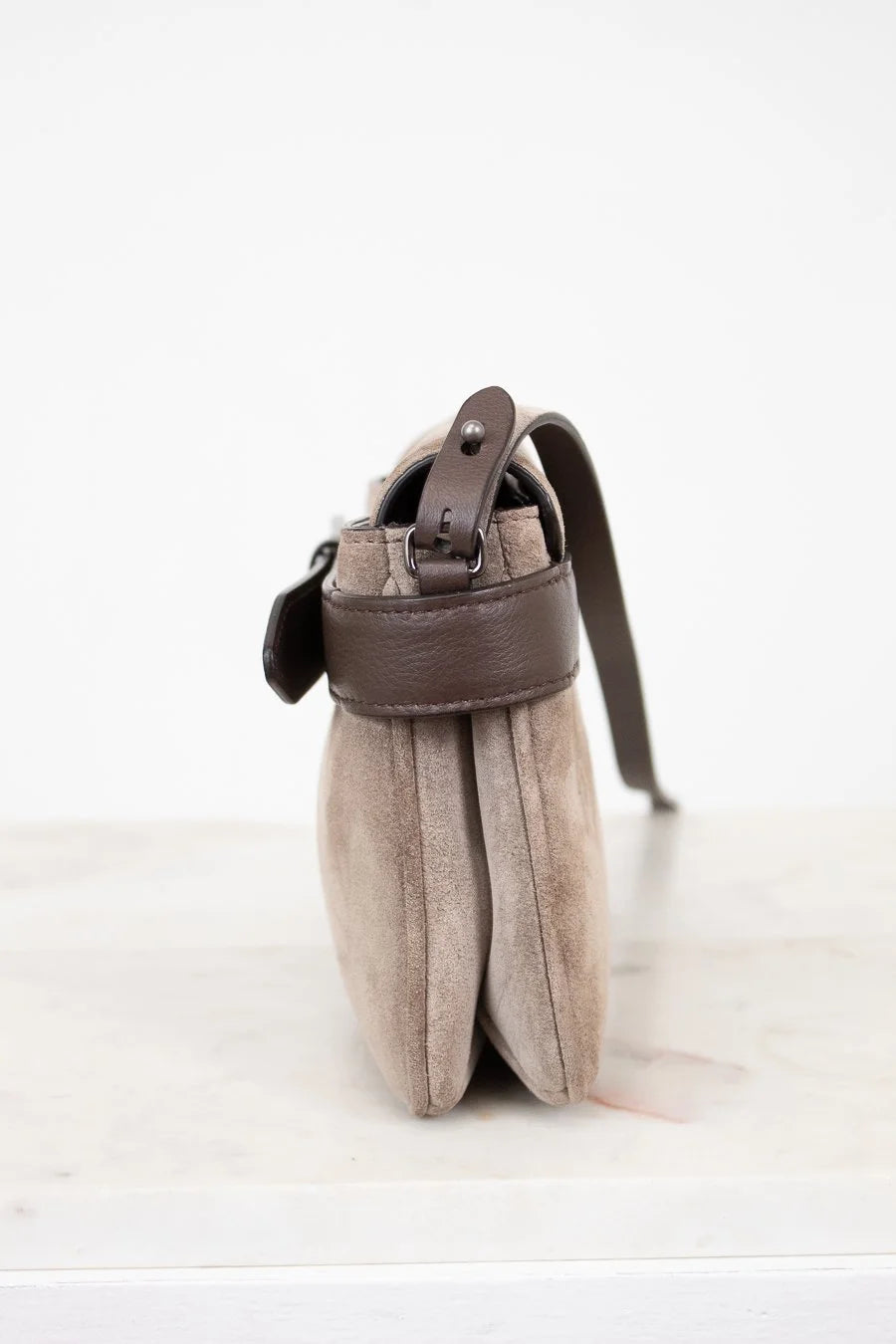Small pouch with a leather strap on a white background