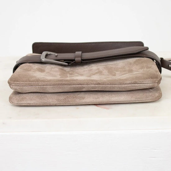 Beige clutch bag with a brown strap on a white background