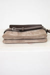 Beige clutch bag with a brown strap on a white background