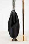 Black handbag with a chain strap on a white background