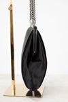 Black clutch bag with a chain strap on a white background