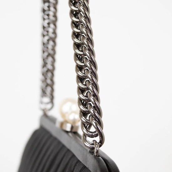 Black handbag with a silver chain strap on a white background