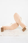 White block-heeled shoes with beige soles on a white background