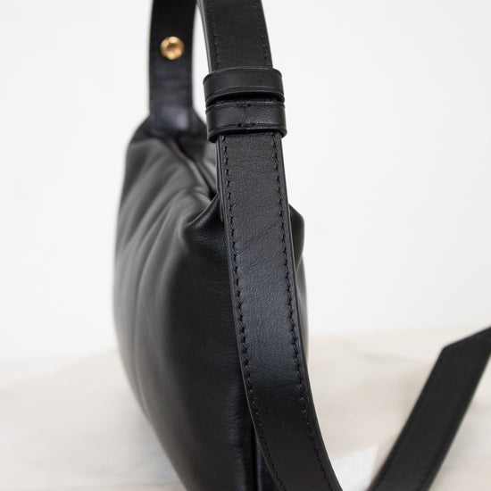 Black leather handbag on a light background