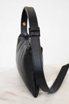 Black leather handbag on a light background
