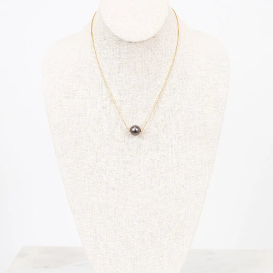 Pearl necklace on a mannequin with a white background