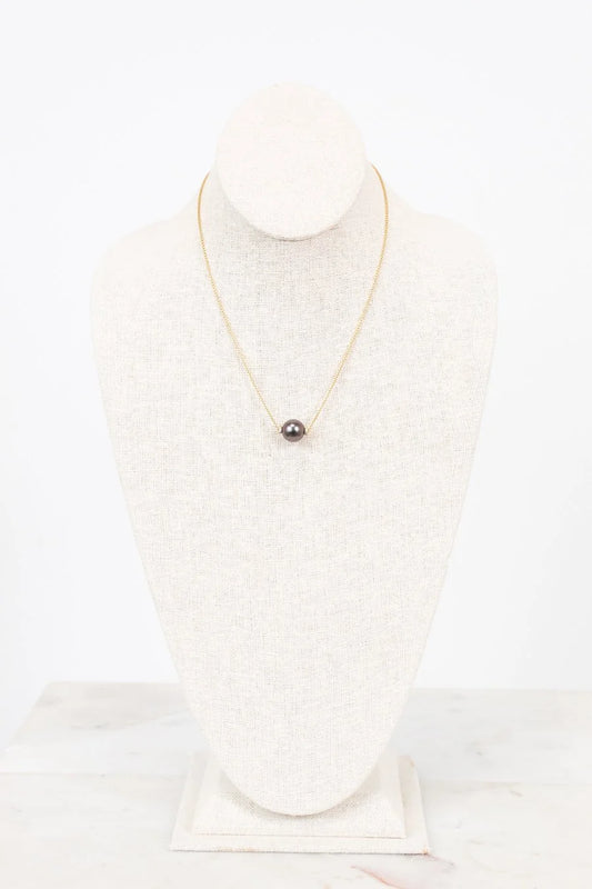 Pearl necklace on a mannequin with a white background