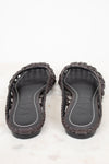 Pair of dark brown sandals with woven design on a white background