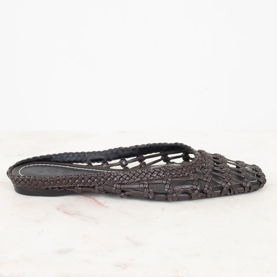 Dark brown woven sandal on a white background