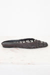 Dark brown woven sandal on a white background