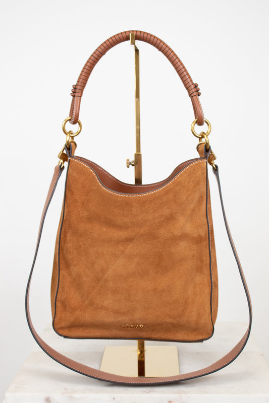 Brown suede and leather handbag with brown handle and strap on a white background