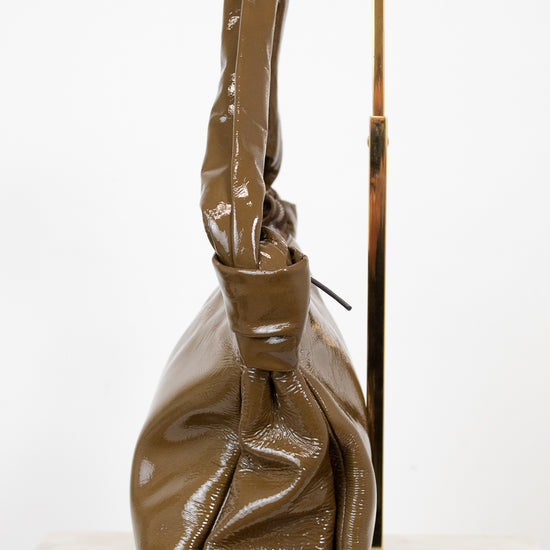 Olive shiny handbag on a white background