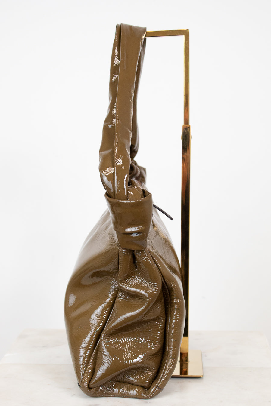 Olive shiny handbag on a white background